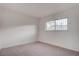 Bright bedroom with neutral carpeting and a window with security bars at 453 Kings Ave, North Las Vegas, NV 89030