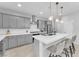 Modern kitchen with gray cabinets, white countertops, and island seating at 4615 Adonis Blue St, North Las Vegas, NV 89031