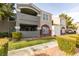 Two-story apartment building with gray and burgundy accents, landscaping, and walkways at 5055 W Hacienda Ave # 1031, Las Vegas, NV 89118