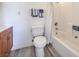 Clean bathroom with a toilet, bathtub, and vanity at 5435 Cortina Ave, Las Vegas, NV 89142