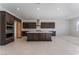 Modern kitchen with dark cabinetry, island, and stainless steel appliances at 5733 Granite Landing Ct, Las Vegas, NV 89131