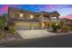 Two-story house with balcony, three-car garage, and desert landscaping at 6116 Rabbit Track St, Las Vegas, NV 89130