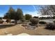 Landscaped front yard with mature trees and rock features at 720 Florida St, Pahrump, NV 89048