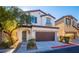 Two-story house with brown garage door and green front door at 7533 Luna Bella Ave, Las Vegas, NV 89179