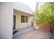 Covered patio with door access and small yard at 7533 Luna Bella Ave, Las Vegas, NV 89179