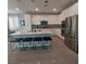 Spacious kitchen boasts stainless steel appliances and a large island at 889 Ariel Heights Ave, Las Vegas, NV 89138