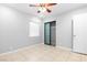 Spacious bedroom with tile floors, ceiling fan, and mirrored closet doors at 917 Bonita Ave, Las Vegas, NV 89104