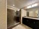 Modern bathroom with walk-in shower and double sinks at 9886 Gold Coin Ct, Las Vegas, NV 89141