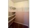 Closet with shelves; pink walls at 9886 Gold Coin Ct, Las Vegas, NV 89141