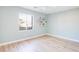 Light green bedroom with wood flooring and floating shelves at 10635 Dawns Mist Ave, Las Vegas, NV 89129