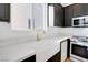 Modern kitchen with white quartz countertops and a farmhouse sink at 10635 Dawns Mist Ave, Las Vegas, NV 89129