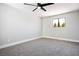 Spacious bedroom with grey carpet, ceiling fan and a window at 1571 Sundown Dr, Henderson, NV 89002