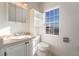 Bathroom with vanity, toilet and window at 170 Story Ave, Pahrump, NV 89060