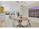 Open dining room with a view into the kitchen and modern light fixture at 1928 Oliver Springs St, Henderson, NV 89052