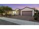 Luxury home with a three-car garage and brick driveway at 1928 Oliver Springs St, Henderson, NV 89052