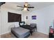 Bedroom with a full-size bed, ceiling fan, and dark window curtains at 2817 Mardi Gras Ln, North Las Vegas, NV 89030