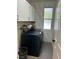 Bright laundry room with modern washer, dryer, and ample storage at 3063 Evening Mist Ave, Henderson, NV 89052