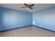 Light blue bedroom with wood-look floors and ceiling fan at 3719 Centennial Cir, Las Vegas, NV 89121