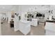 Open concept kitchen with white cabinetry, island, and views into the living room at 3759 Tundra Swan St, Las Vegas, NV 89122