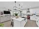 Modern kitchen with white cabinets, a large island, and stainless steel appliances at 3759 Tundra Swan St, Las Vegas, NV 89122