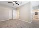 Bright bedroom with ceiling fan, carpet, and access to bathroom at 5415 W Harmon Ave # 1051, Las Vegas, NV 89103