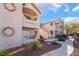 Building exterior with walkway, landscaping, and Spanish-style architecture at 5415 W Harmon Ave # 1051, Las Vegas, NV 89103