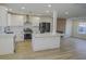 Modern kitchen with white cabinets, quartz countertops, and stainless steel appliances at 8637 Tivoli Ct, Las Vegas, NV 89117