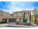 Two-story house with brown garage door and landscaping at 961 Rock Ledge Ct, Henderson, NV 89012