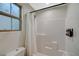 Clean bathroom with shower, toilet and white tile at 10176 Campo Tizzoro Ave, Las Vegas, NV 89147