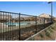 Community pool area with black metal fence at 1640 Karst Pond Ave, North Las Vegas, NV 89084