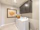 Bright laundry room featuring washer, dryer, and dark brown cabinets at 1917 Lewis Bay Ave # Lot 22, North Las Vegas, NV 89084