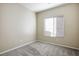 Simple carpeted bedroom with a window at 221 Gemstone Hill Ave, North Las Vegas, NV 89031