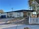 Ranch style home with wood front door and picket fence at 2318 Howard Dr, Las Vegas, NV 89104