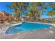 L shaped community pool with surrounding patio furniture at 2360 Pickwick Dr, Henderson, NV 89014