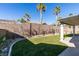 Landscaped backyard with covered patio and grassy area at 3315 Garden Shower Pl, Las Vegas, NV 89135