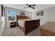 Spacious bedroom with a large sleigh bed and ample natural light at 4529 Swimming Minnow Ave, Las Vegas, NV 89141