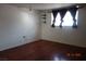 Simple bedroom with wood floors and mirrored closet doors at 4709 W Alpine Pl, Las Vegas, NV 89107