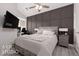 Bedroom with dark-brown paneled feature wall and neutral bedding at 841 Santa Theresa Way, Mesquite, NV 89027