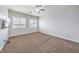 Bright bedroom with carpet, ceiling fan and window shutters at 90 Einstein Ridge Way, Las Vegas, NV 89183