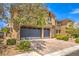 Two-story house with stone accents and two-car garage at 90 Einstein Ridge Way, Las Vegas, NV 89183