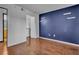 Bedroom with hardwood floors and a navy blue accent wall at 950 Seven Hills Dr # 714, Henderson, NV 89052