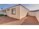 Side yard view of the home with gravel and a white fence at 1016 Chestnut Bay Ave, North Las Vegas, NV 89031