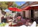 Relaxing patio area with red umbrellas, seating, and a decorative wall at 1607 Coal Valley Dr, Henderson, NV 89014