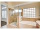 Bathroom boasts a shower, bathtub, and a large window at 1708 Jack Rabbit Way, Las Vegas, NV 89128