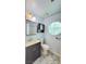 Updated bathroom with vanity, toilet, and stained glass window at 1940 Whiton St, Las Vegas, NV 89156