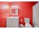 Bathroom with red walls, white vanity, and shower/tub at 2986 Juniper Hills Blvd # 204, Las Vegas, NV 89142