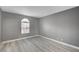 Bedroom with gray walls, wood-look floors, and arched window at 2986 Juniper Hills Blvd # 204, Las Vegas, NV 89142