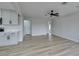 Open concept kitchen and living area with modern cabinetry and wood-look floors at 341 Bedford Rd, Las Vegas, NV 89107