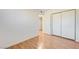 Simple bedroom with wood flooring and mirrored closet doors at 366 Linn Ln, Las Vegas, NV 89110