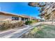 View of a complex of charming single-story homes with a walkway and grassy area at 366 Linn Ln, Las Vegas, NV 89110